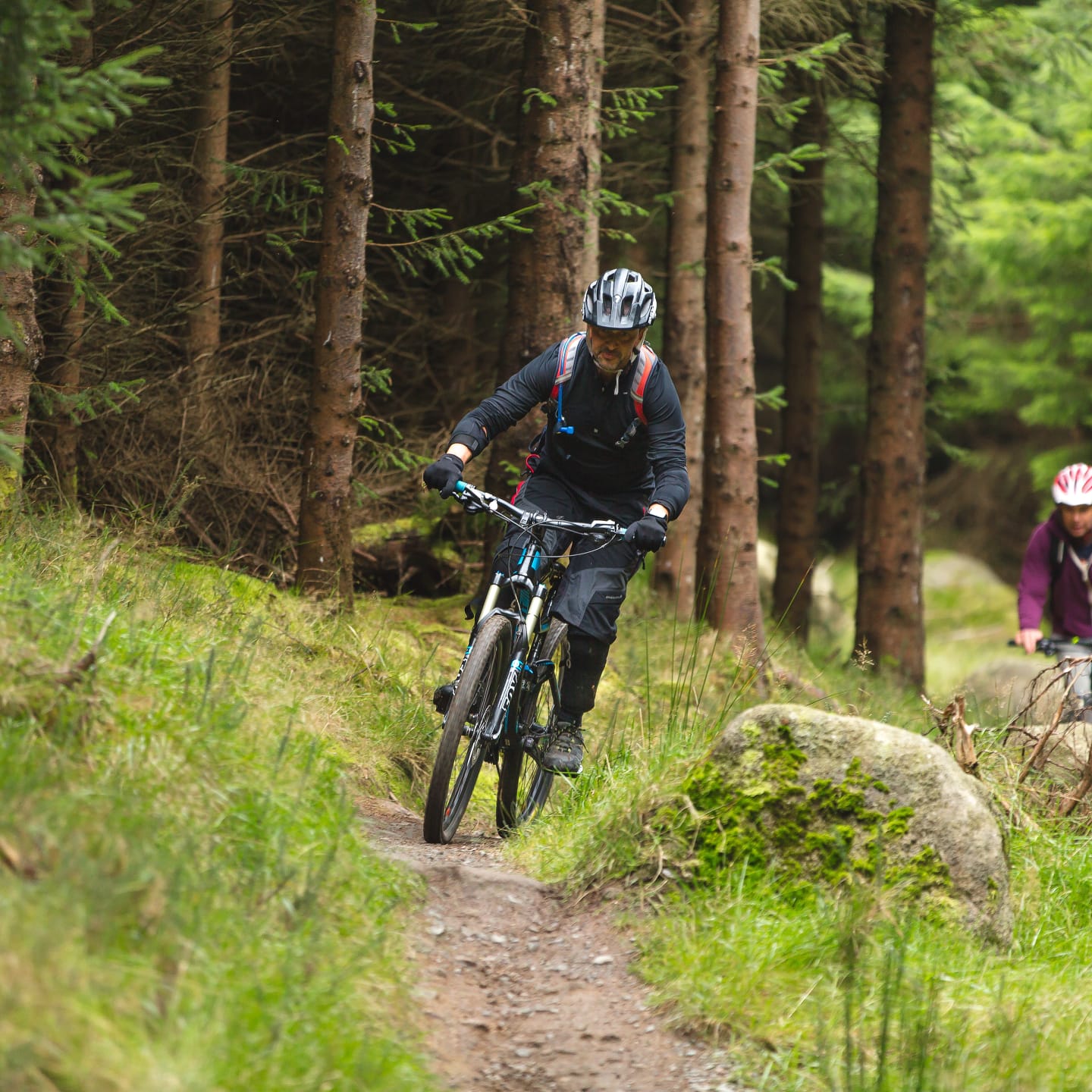 Mountain biker riding through forest