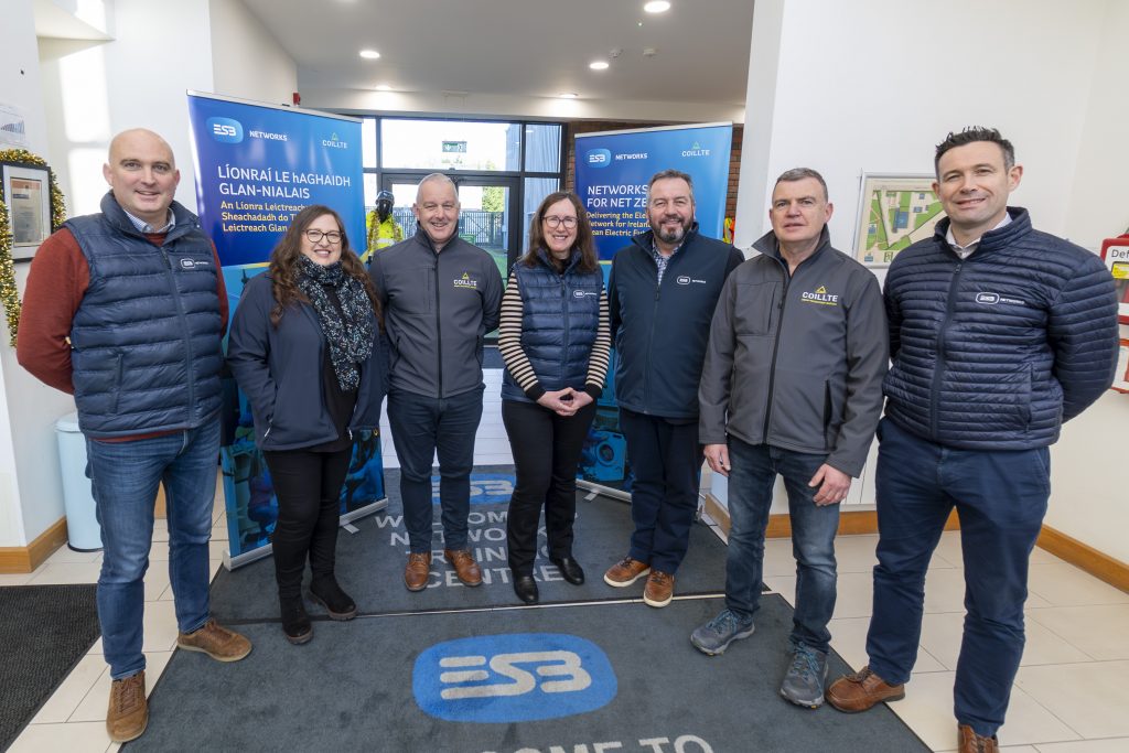 Group of ESB & Coillte staff pose for photo in front of ESB banners