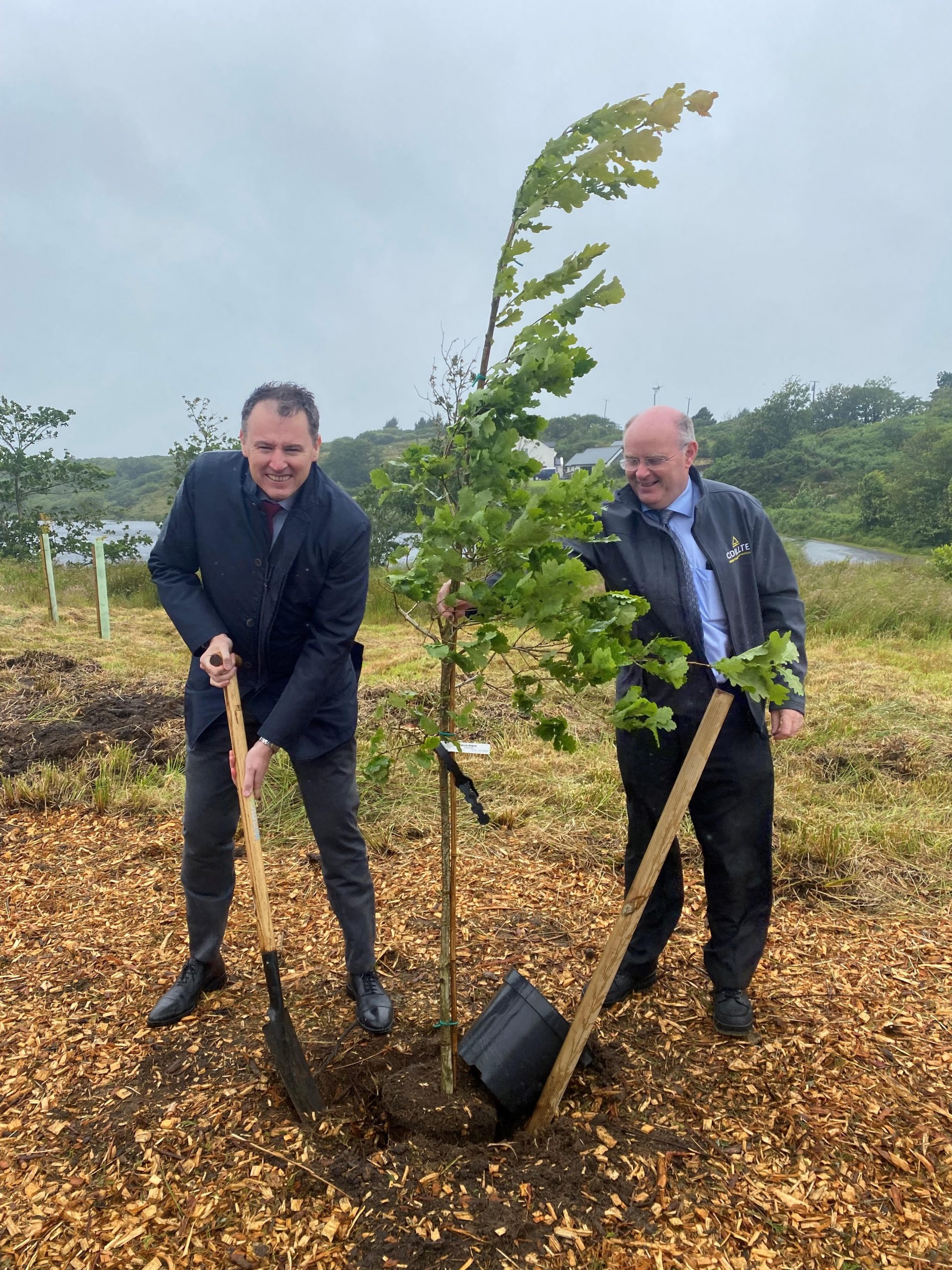Minister Charlie McConalogue and Coillte's Regional Manager plant a tree to mark the opening of Coillte's Bonny Glen recreational forest